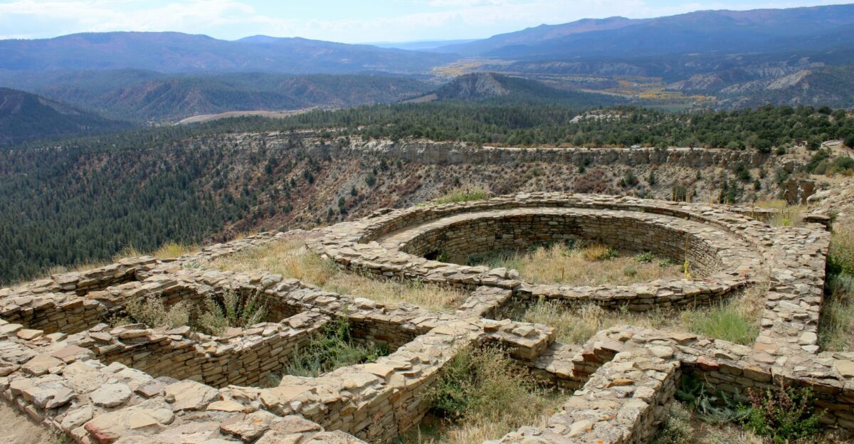 a stone structure in the middle of a mountain range