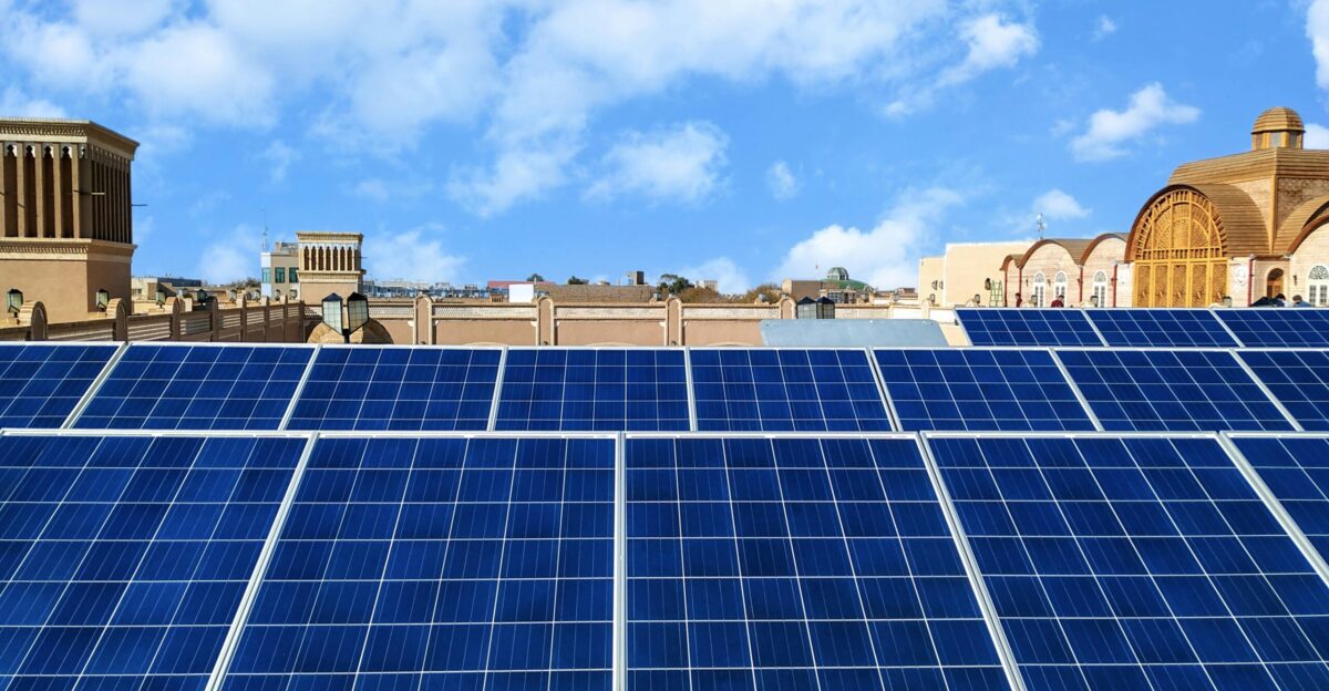 a row of solar panels on the roof of a building