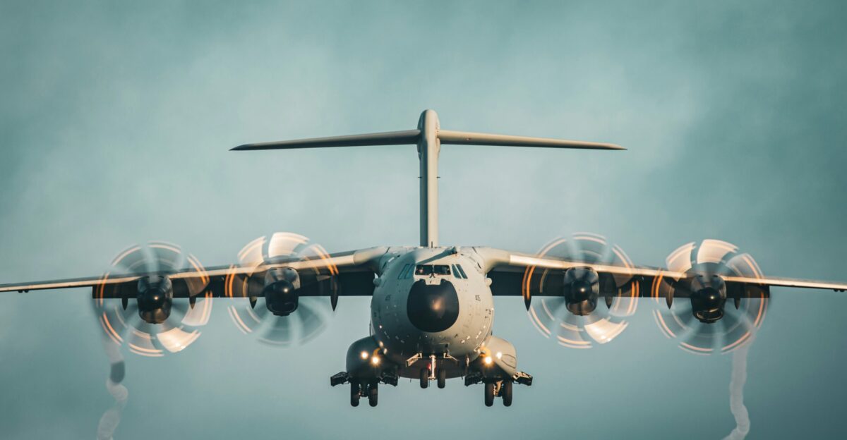 a large jetliner flying through a cloudy blue sky