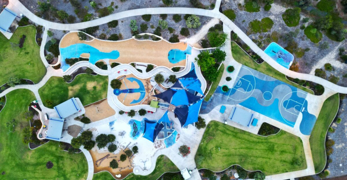 an aerial view of a park with a swimming pool