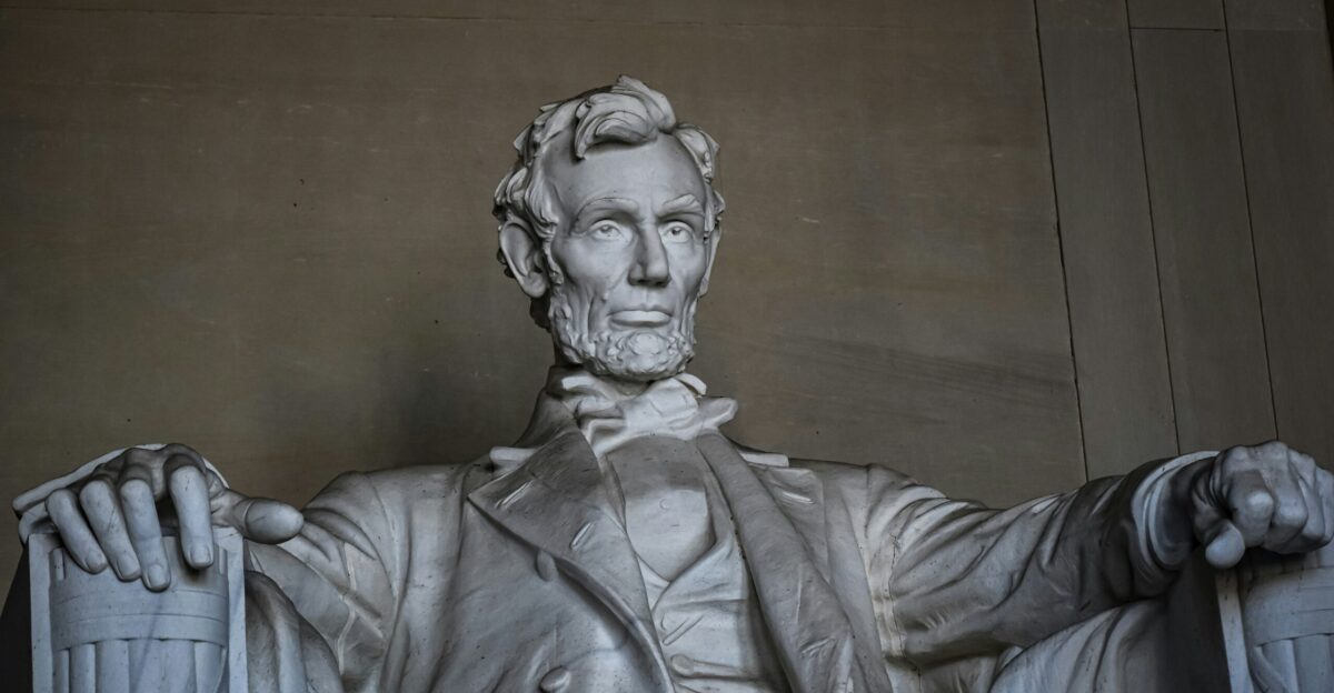 a statue of abraham lincoln holding a cane