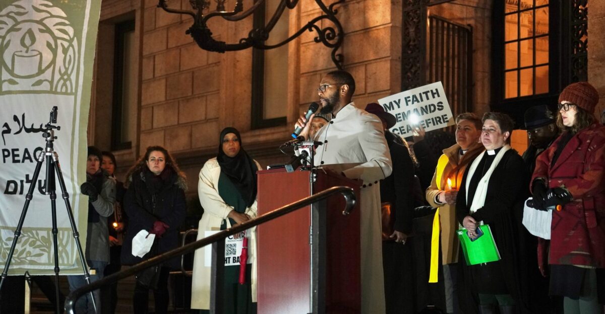 a man standing at a podium with a microphone