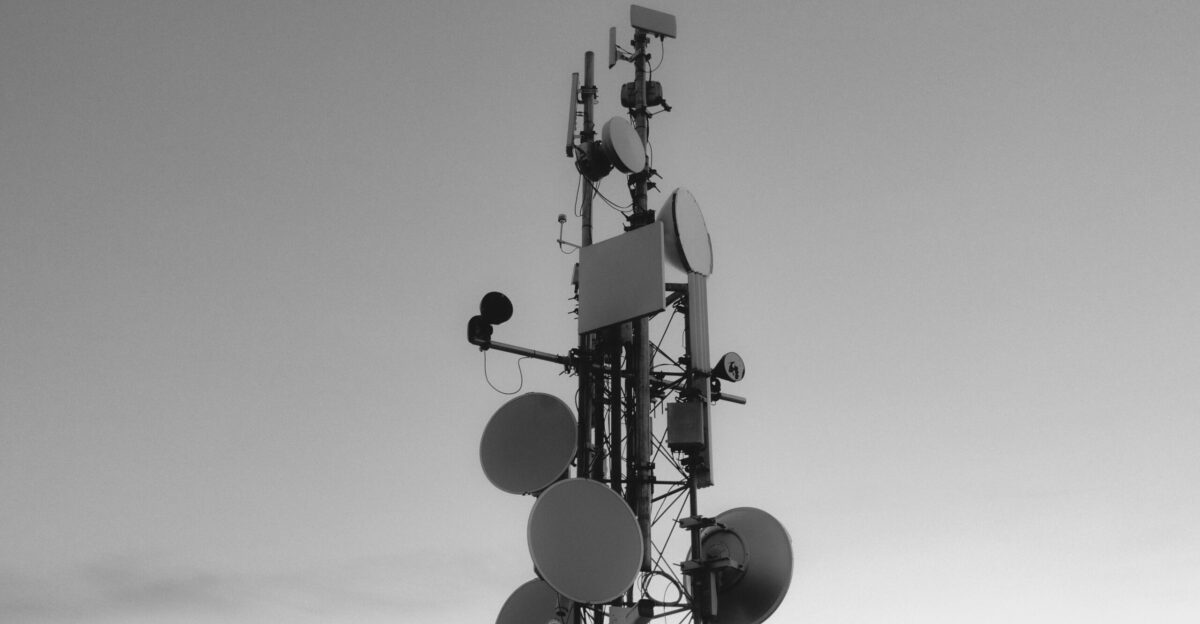 a black and white photo of a cell phone tower