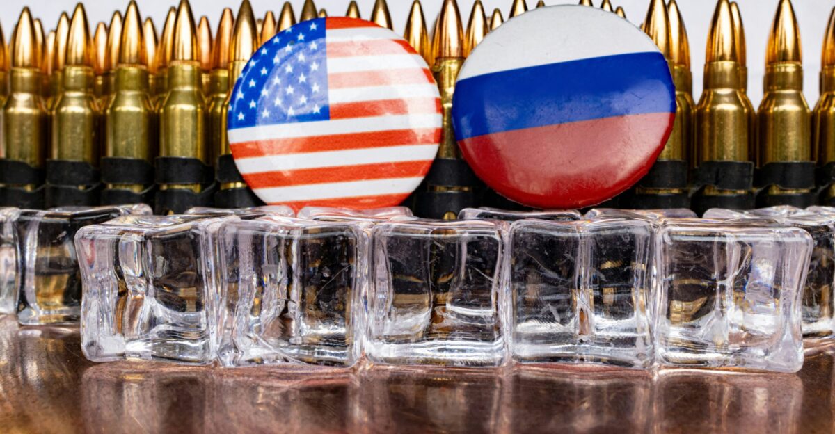 a bunch of bullet casings with flags on them