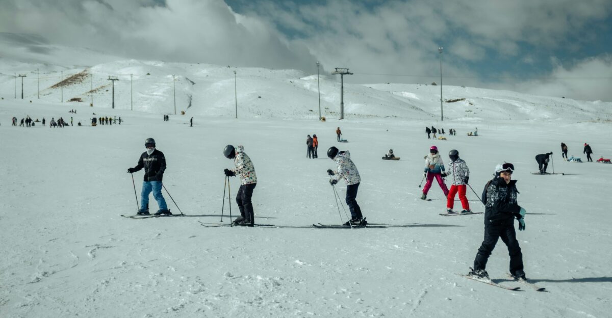 a group of people riding skis on top of a snow covered slope
