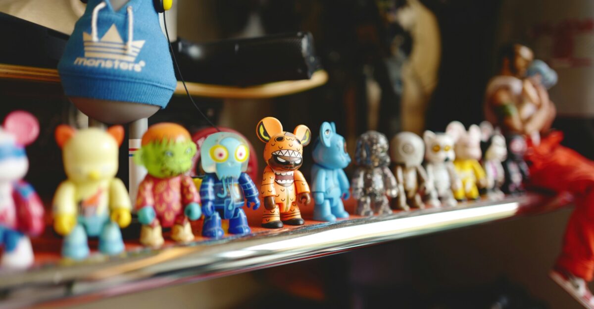 a bunch of small toy animals sitting on a shelf
