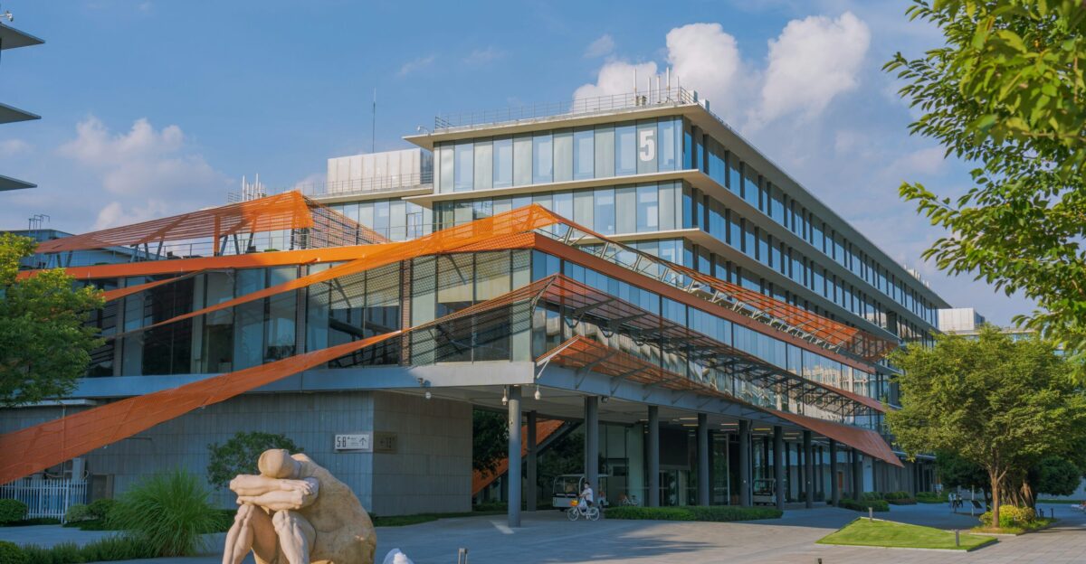 a large building with a sculpture in front of it