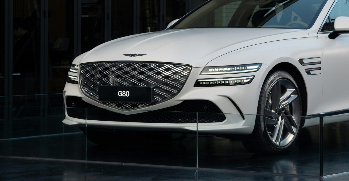 a white car parked in front of a building