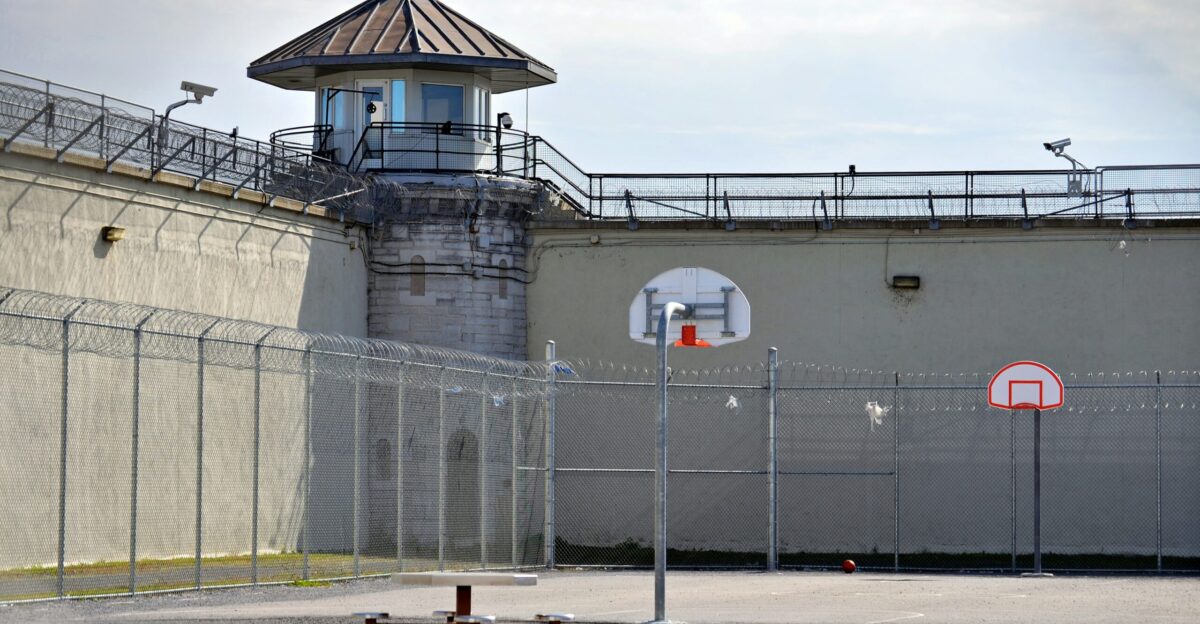 a basketball court in front of a jail cell
