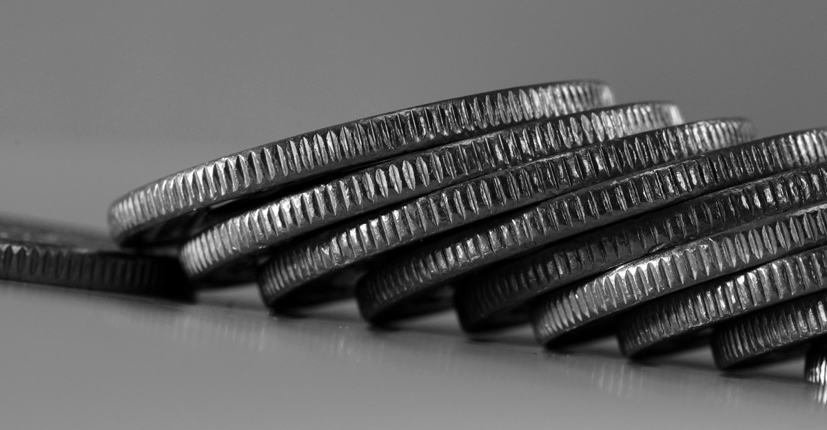 a stack of silver coins sitting on top of a table
