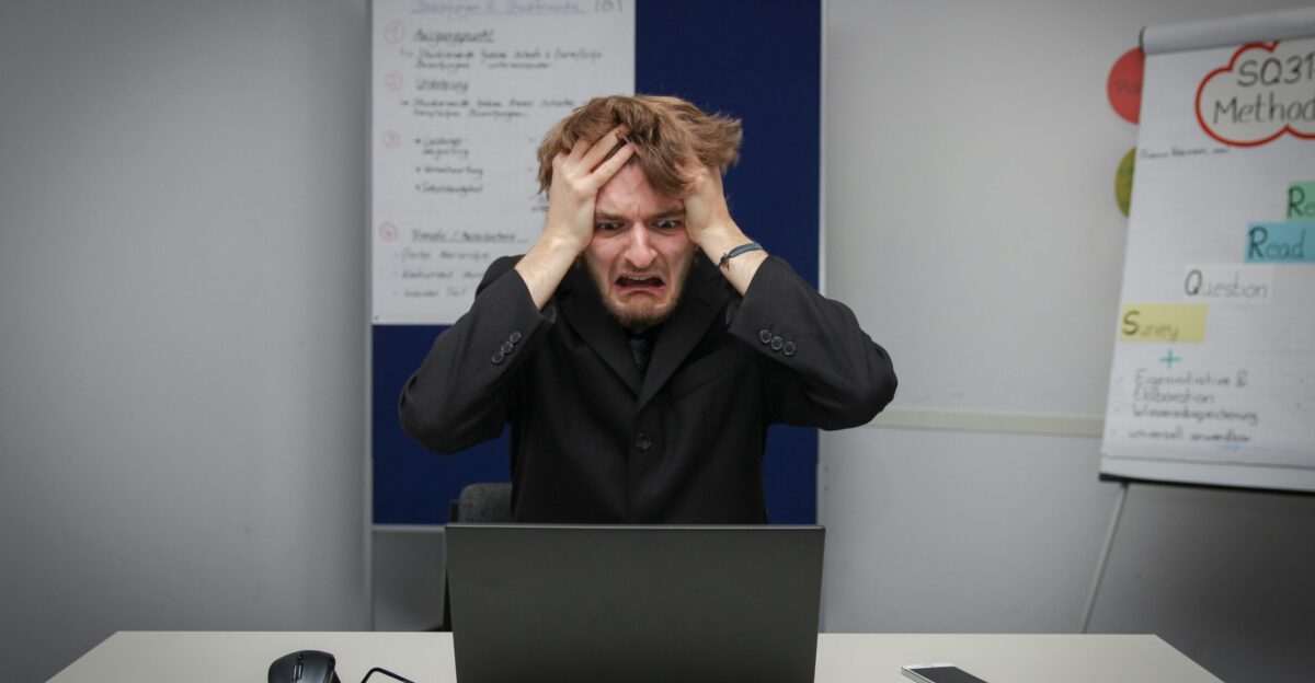 A man sitting in front of a laptop computer