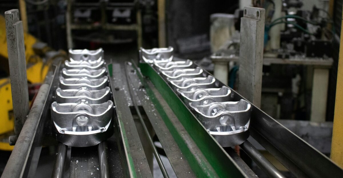 A conveyor belt with a bunch of metal objects on it