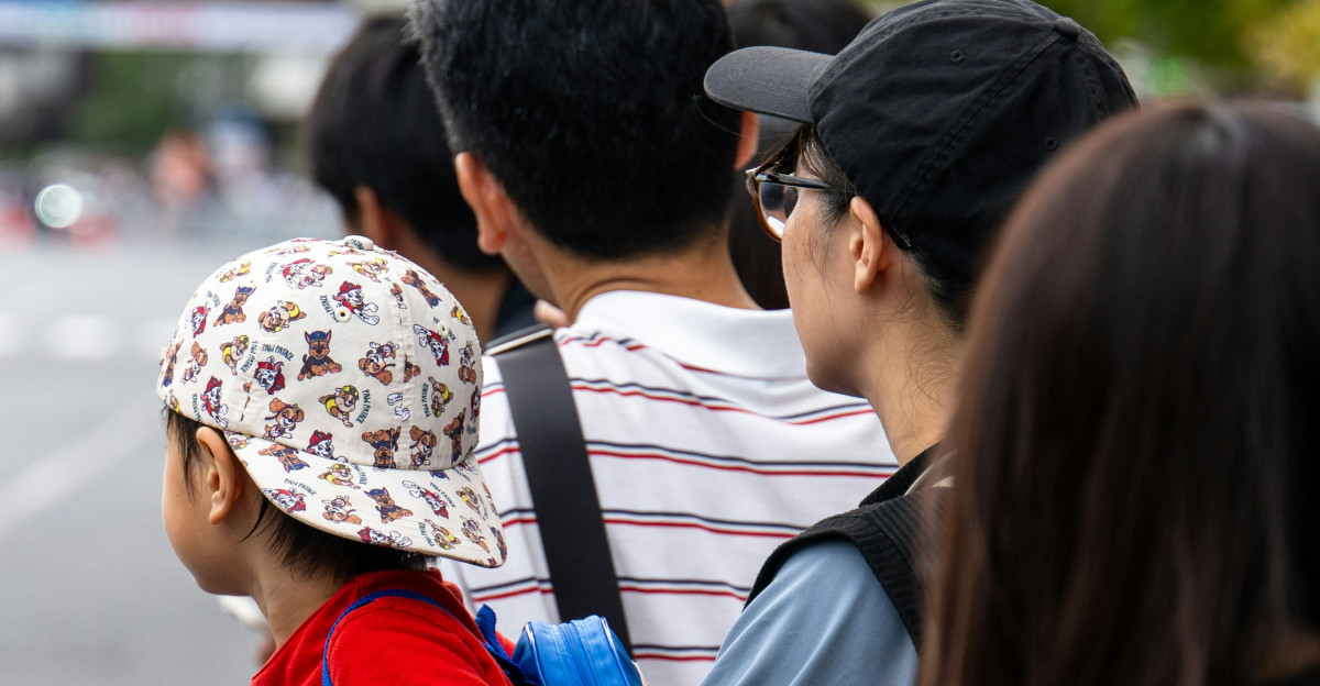 A group of people standing on the side of a road