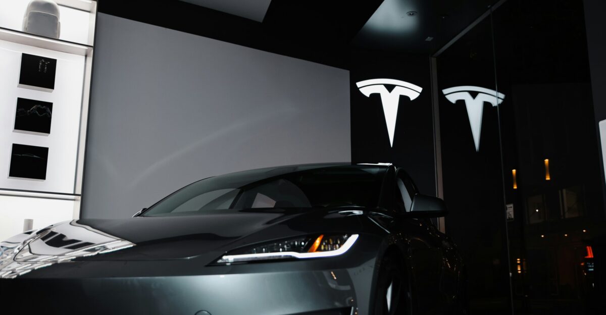 A car parked in front of a large screen