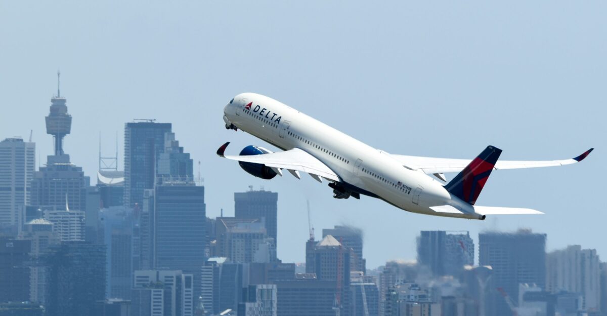 A large passenger jet flying over a city