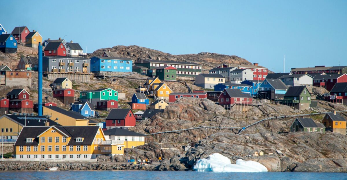 A small town on a hill with a body of water in front of it