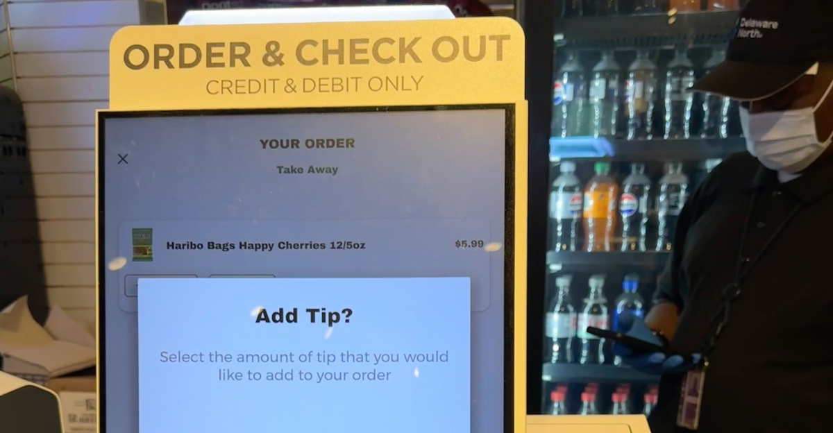 A checkout counter with a cell phone on it