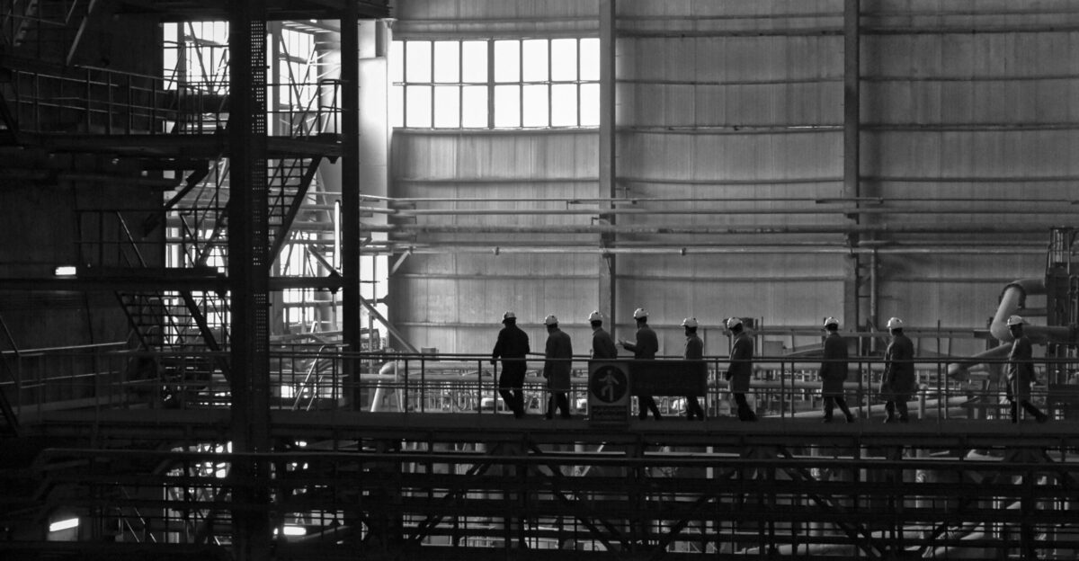 A group of people walking across a bridge
