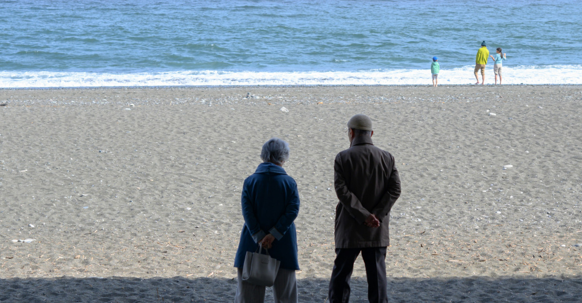 Couple observes the ocean on a serene beach