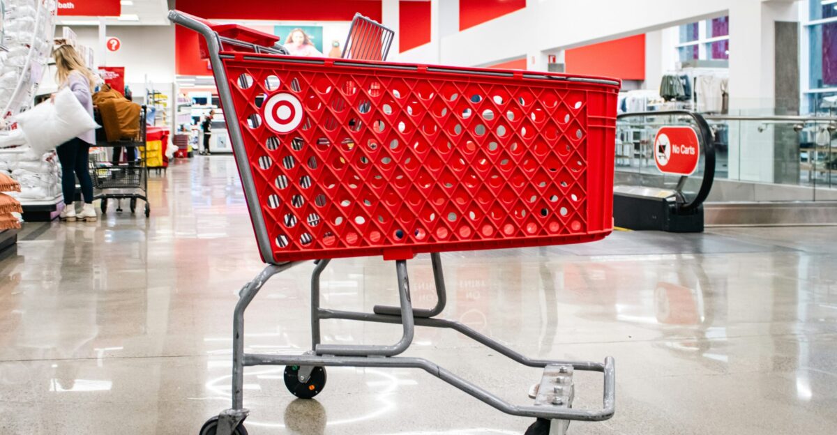 A red target shopping cart sits in an aisle