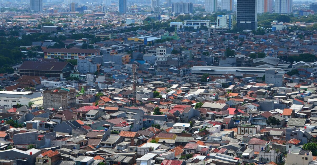A densely packed city with skyscrapers in the distance