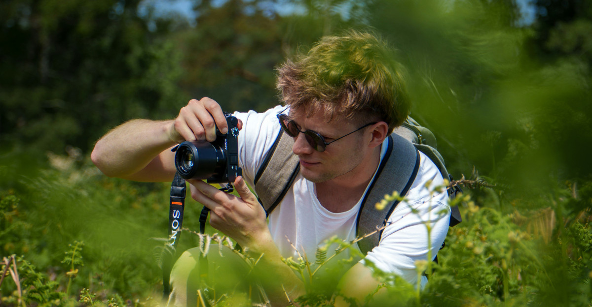 A man takes a photo in nature