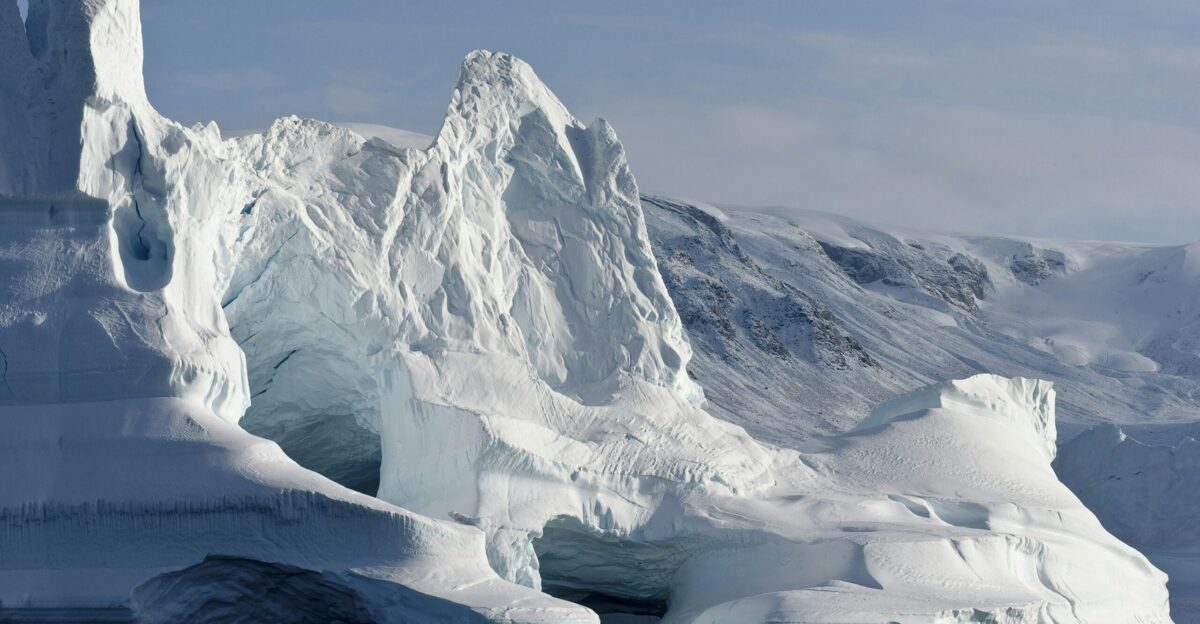 A majestic iceberg rises above the ocean