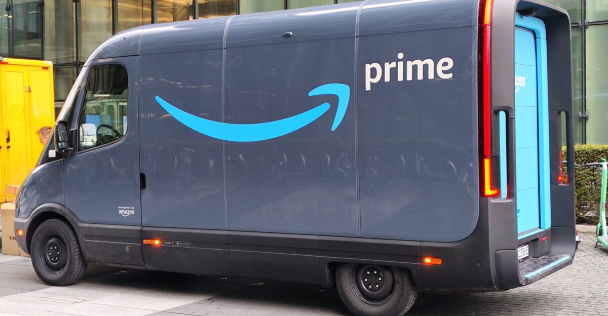 Rivian transporter with Amazon Prime branding parking in front of the Highlight Towers in Munich