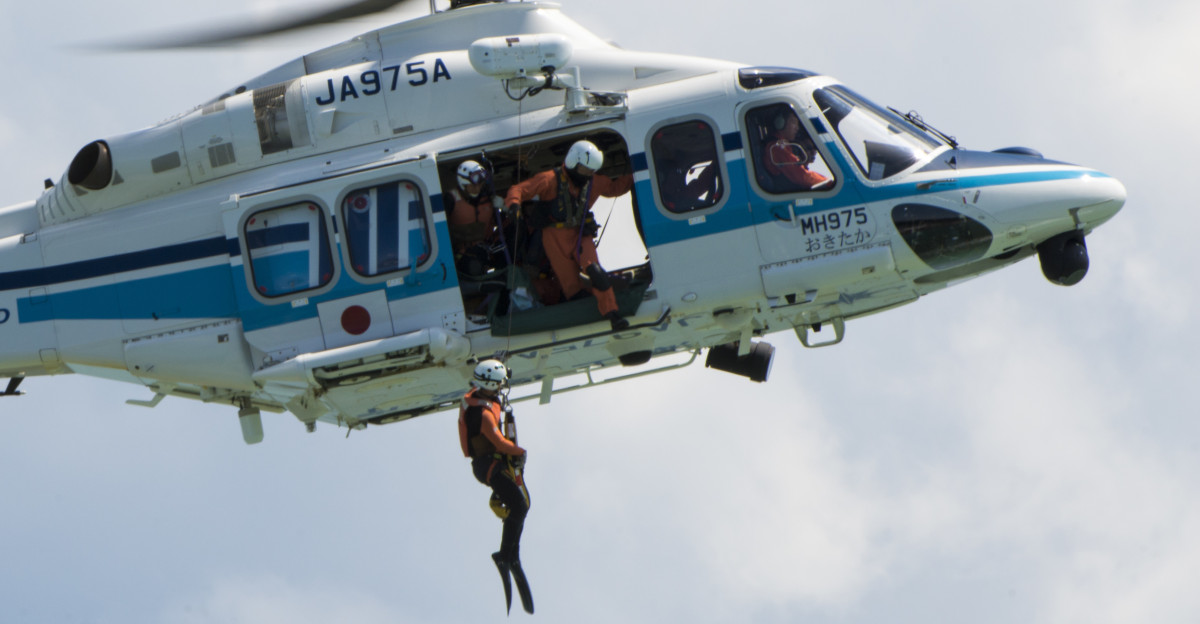 A Japan Coast Guard S-76D hovers as members lower a rescue swimmer during an annual Okinawa Prefectural Government bilateral disaster response exercise at Atta Port Japan Sept 5 2015 The scenario centered on the evacuation and rescue of Okinawa inhabitants following a deadly tsunami hitting the island s eastern coast A total of 82 separate entities from the U S military Japan Self-Defense Force and local emergency responders worked together to ensure the success of the exercise U S Air Force photo by Staff Sgt Maeson L Elleman Unit 18th Wing Public Affairs