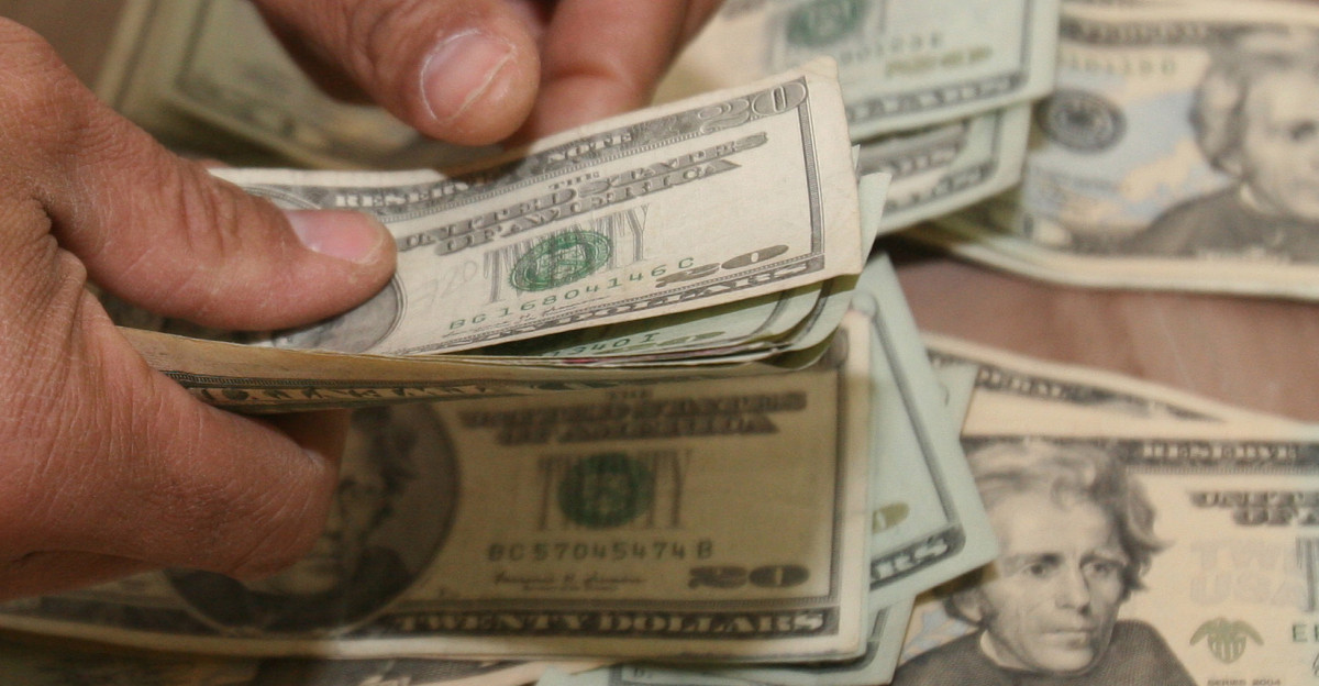Lieutenant Col Robert Glover director of the Al Qaim regional Civil-Military Operations Center counts out the money in a condolence payment to an Iraqi citizen whose home was damaged in a mortar attack The CMOC is a function of 6th Civil Affairs Group in Husaybah Iraq