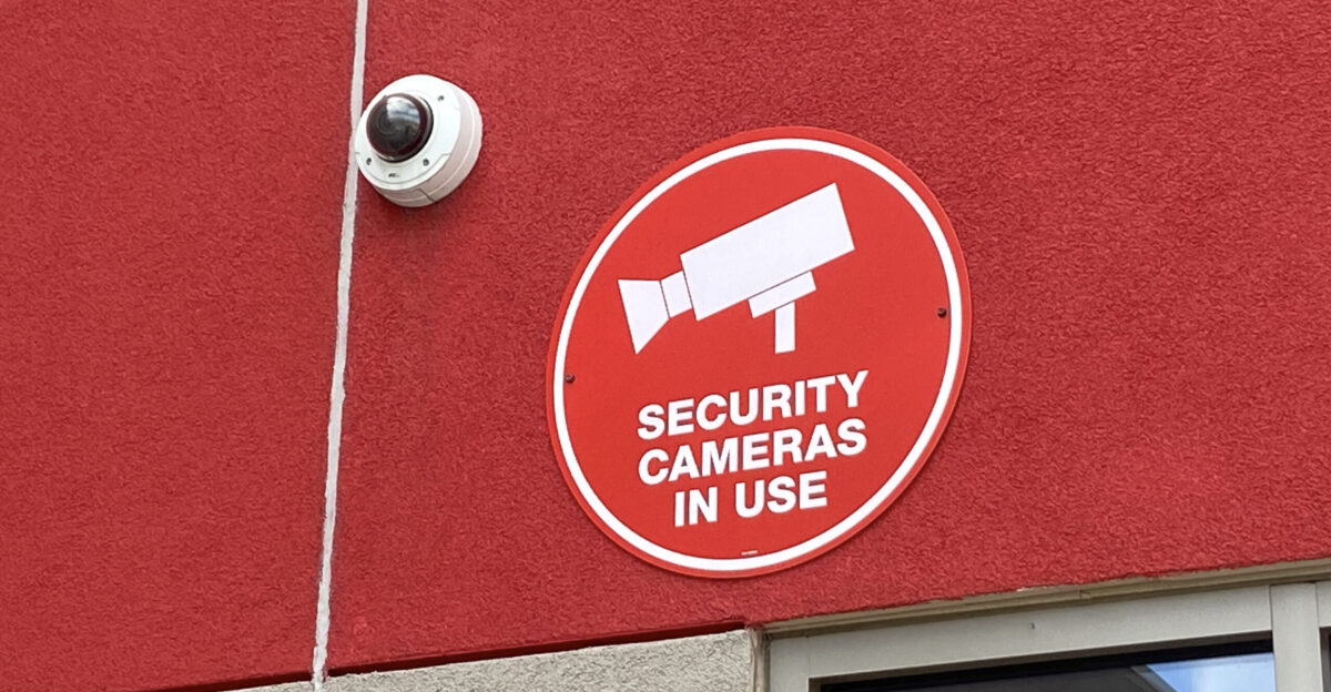 Exterior vandal dome-style security camera next to signage alerting of Security cameras being used to monitor activities Target store near Southtown Bloomington Minnesota United States