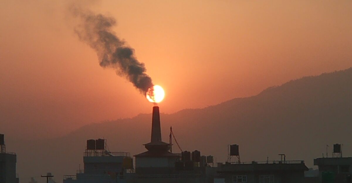 Air pollution by brick factories The sun can be seen in the background just above the factory chimney partially covered by the chimney s smoke
