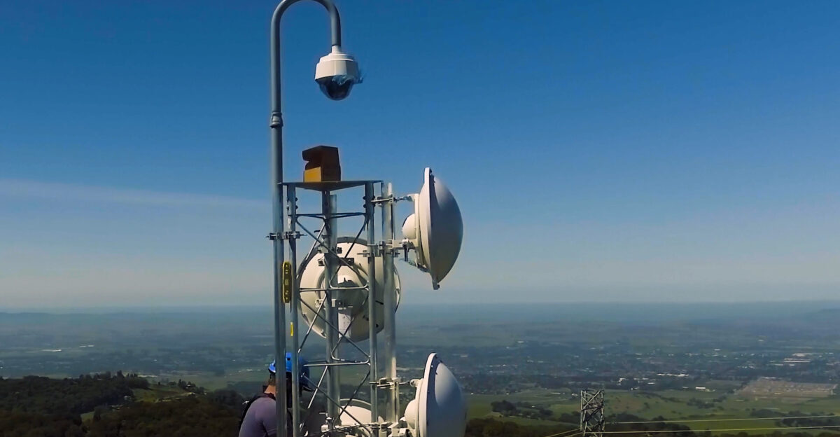 As fire seasons have become longer and more devasting firefighters have looked to wide variety of technologies to assist with detection and response The Alert Wildfire detection camera project which began over a decade ago was developed in conjunction with the Bureau of Land Management BLM Oregon Washington BLM Idaho BLM Nevada and University of Nevada Reno - Nevada and University of Oregon s Seismological Laboratories In 2004 the University of Nevada Reno developed a stand-alone microwave network to support the change from analog to digital seismic station sensors The microwave system runs on an unlicensed broadband public safety band that is networked across the states This system has evolved from just transmitting seismic data to the current wildfire detection video data from stations and cameras located primarily on BLM-permitted lands The cameras and associated tools help firefighters and first responders discover locate confirm fire ignition quickly scale fire resources up or down appropriately monitor fire behavior through containment during firestorms help evacuations through enhanced situational awareness ensure contained fires are monitored appropriately through their demise and view prescribed fires both during ignition and during monitoring stages The camera network is fed by a single point mountaintop camera via microwave to central hosting point at the University of Nevada Reno The cameras are 1080 high definition high speed with pan tilt and zoom capabilities The cameras also provide a live feed of for designated users of six frames per second Cameras provide a remote feed to a web page that updates the pictures every 10 seconds Over the last several years this innovative technology has provided critical information for thousands of fires throughout the western U S In Fiscal Year 2022 the Oregon Washington Bureau of Land Management awarded the University of Oregon UO 718 346 to help aid in wildfire prevention by developing the most integrated and interorganizational wildfire detection system in the United States Funding will provide continued statewide access to vital information of emergent wildfires and provide for the most efficient and effective emergency response thereby ensuring the quality of lives of Oregonians and protecting our natural resources In 2022 the BLM helped lead the establishment of an Oregon Statewide Wildfire Detection Camera System with the goal of establishing collaborative governance to establish and implement a statewide wildfire detection camera strategy that addresses a long-term detection camera build-out between the multiple agencies while also addressing current and future detection camera technologies The ALERTWildfire program continues to grow the ability to locate smoke at a very early stage will ultimately allow firefighters more time to assess the situation and mobilize appropriate resources This unique use of technology will save taxpayers money as well as our forests grasslands property and lives while managing risk to our firefighters through an informed response The 41 wildfire detection cameras covering Oregon and Washington can be viewed online at Photo University of Nevada Reno