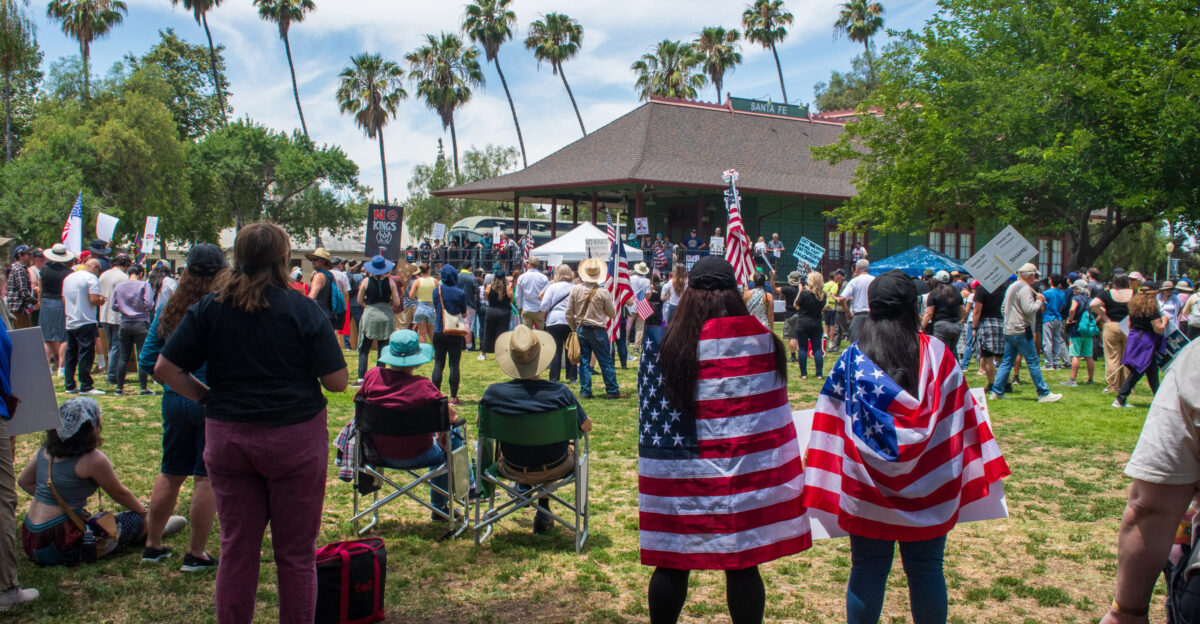 People listening to speakers after the march