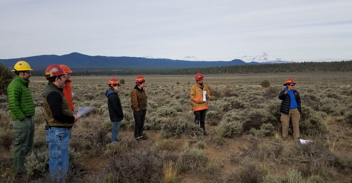 Alison Dean COFMS discusses the enviromental gradient of the east Cascades Prescribed fires help our forests grasslands and other vegetation stay healthy They create more diversity and reduce crowded brushes that fuel wildfire Through the Fire Learning Network a joint project with The Nature Conservancy Department of the Interior and Forest Service with participants from a variety of agencies and cooperators students gather to learn from each other and share expertise in prescribed fire management Photo taken by Lisa McNee BLM on May 1 2018
