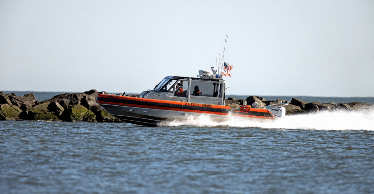 A Coast Guard RB-S Response Boat stationed at U S Coast Guard Station Barnegat Light heads back to the bay through teh Barnegat Inlet