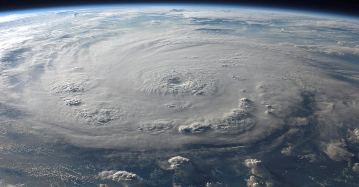 A stunning aerial view of Earth with a massive swirling hurricane highlighting meteorological beauty