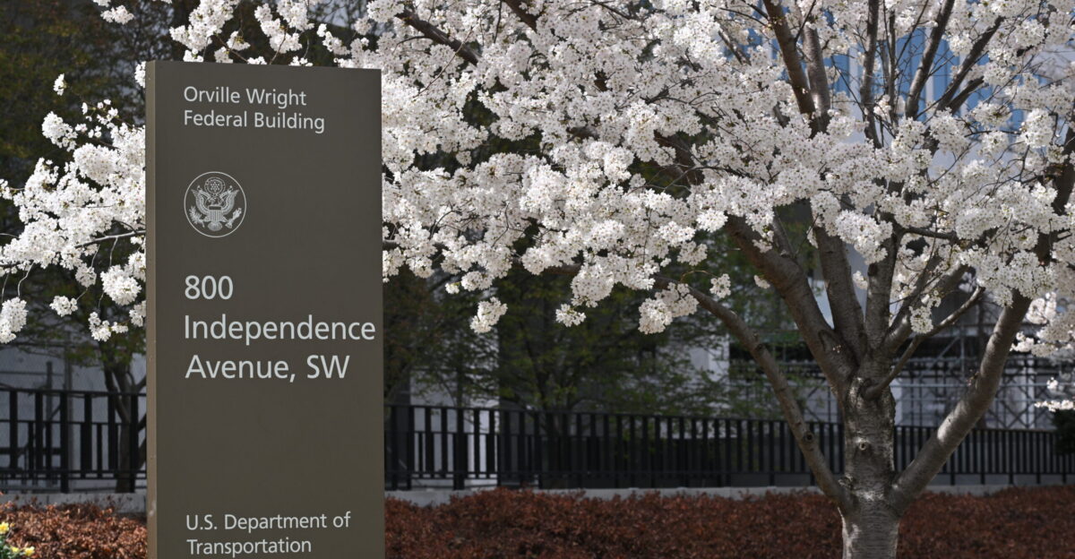 The sign for the Orville Wright Federal Building which houses the U S Department of Transportation DOT and the Federal Aviation Administration FAA Behind the sign is a cherry tree in full bloom 800 Independence Avenue SW Washington DC 20024
