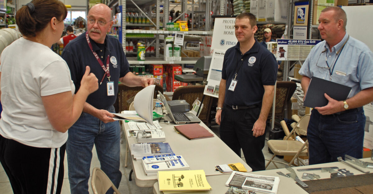 Sulphur LA 1-26-06 - Ellie Newby talks with FEMA mitigation Specialists Braden Allen and John Ormsby and NFIP Specialist Tom McDermott about wind proofing hardware repairs at this mitigation display at Lowe s Building supplies FEMA puts these Mitigation displays in public places to give people who need to build or rebuild choices in making a better building that will resist damage better MARVIN NAUMAN FEMA photo