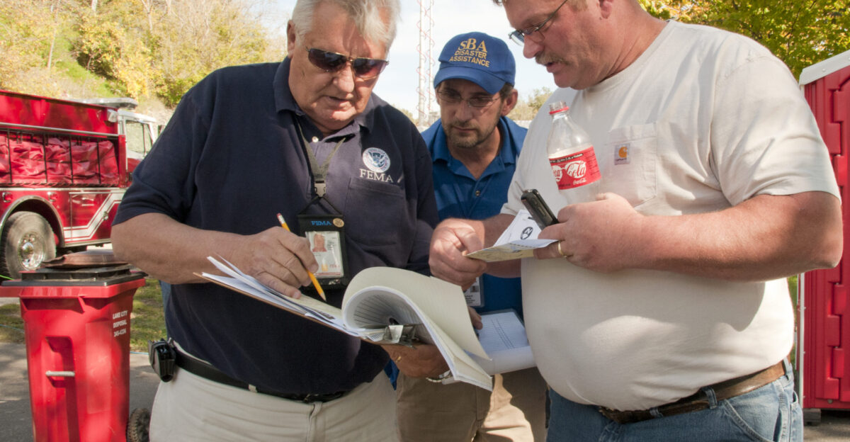 Zumbro Falls MN September 27 2010 - Duane Tuttle a FEMA individual assistance specialist goes over the areas affected by flooding with Alan VanDerWalker the Zumbro Falls mayor while Rich Barto the SBA representative looks Dozen of homes were damages Friday September 24 2010 when flood waters engulfed the town of Zumbro Falls FEMA and the Minnesota Emergency Management Agency was in town conducting damage assessments which will allow the Governor to determine if the state is eligible for federal assistance Photo by Patsy Lynch FEMA