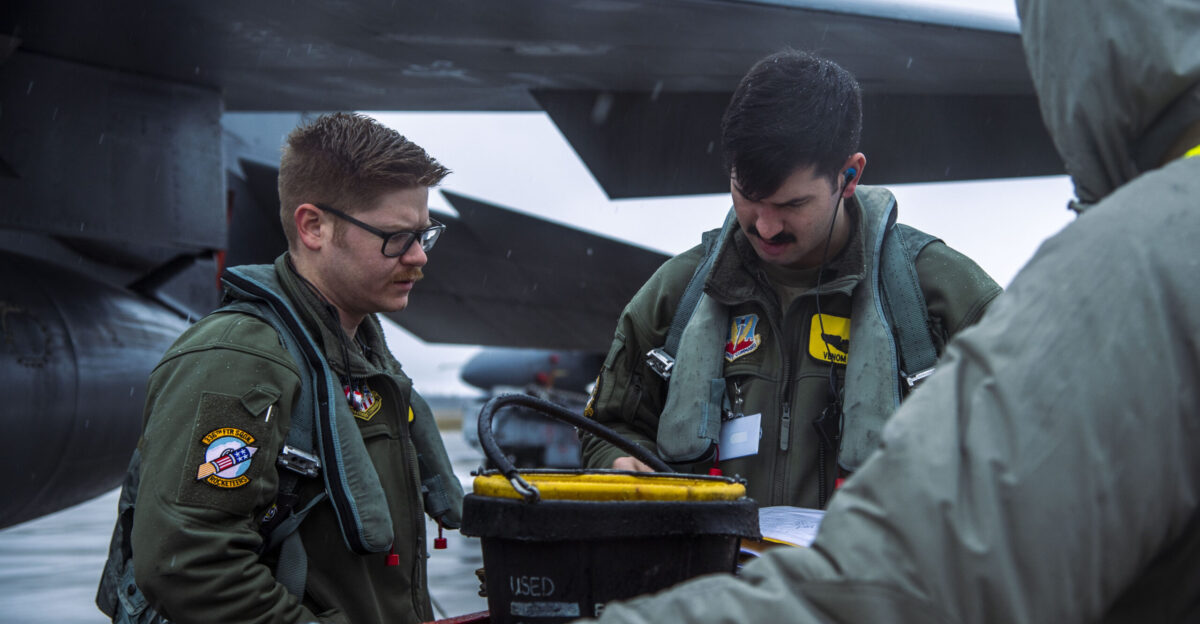 U S Air Force Capt Sam Simmons left 336th Fighter Squadron weapons systems officer from Seymour Johnson Air Force Base N C and Capt Andrew Gikas center 336 FS pilot prepare to practice alert launches in the F-15E Strike Eagle at mari Air Base Estonia Jan 27 2022 The F-15E Strike Eagles along with Belgian F-16s are deployed to mari AB in support of a NATO enhanced Air Policing mission The Belgian Estonian and U S Air Forces are conducting flying operations together to protect and defend allied airspace This deployment is focused on enhancing the deterrence air posture in the Baltic region U S Air Force photo by Staff Sgt Megan M Beatty