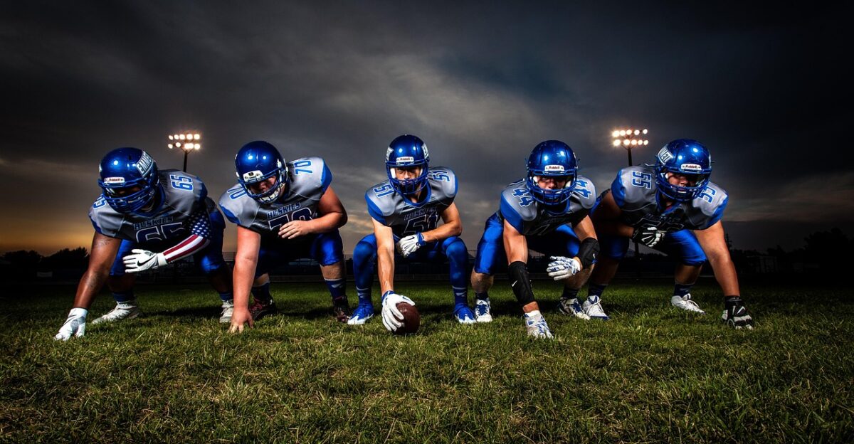 athletes american football players football team football players football field team ball field football game grass nature helmets men people rugby sport stadium uniforms