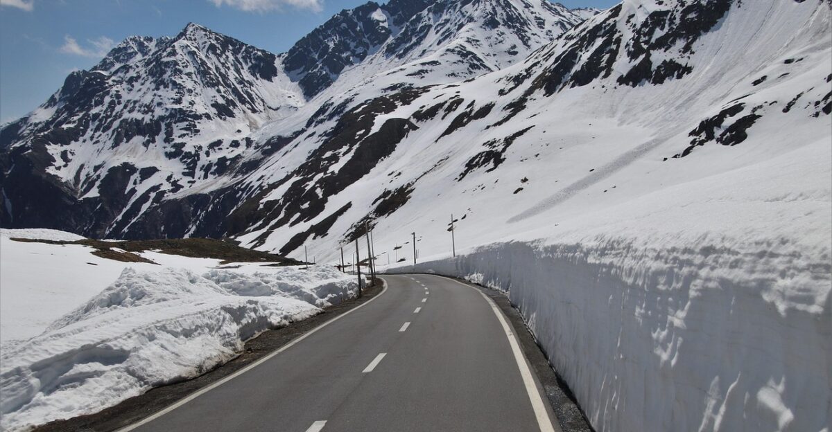 the side of the road snow mountains nature the stage steep pass asphalt peak switzerland high array the height of the mountain overlap travel perspective the alps scenery silence alpine highway a lot of snow snow drifts sunny day