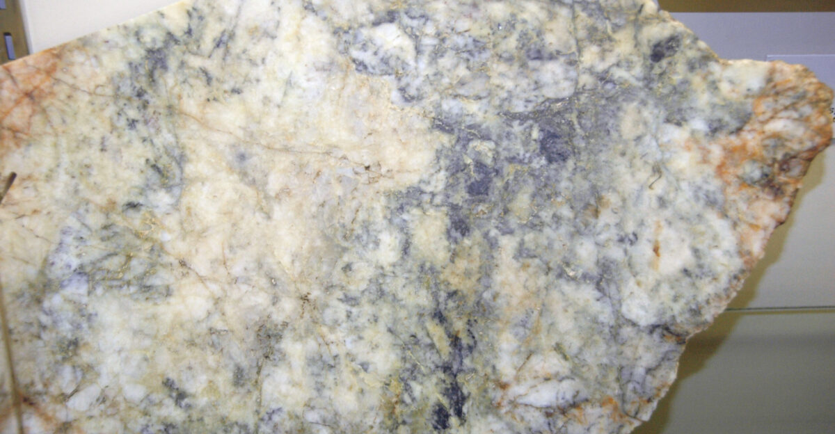 Gold-quartz-sulfide hydrothermal vein from the Cretaceous of Alaska USA cut polished slab public display Leadville Mining Museum Leadville Colorado USA This is hydrothermal vein rock from the Grant Mine northwest of the city of Fairbanks Alaska The mine produced gold silver antimony lead and tungsten Two hydrothermal veins were the principal targets of mining at this locality - the O Dea Vein and the Irishman Vein This specimen may be from the O Dea Vein which varies in width from 6 inches to over 6 feet Both veins are developed in fault zones in Fairbanks Schist host rocks of probable Proterozoic age The rock is dominated by whitish quartz this has been described as a quartz breccia which has been mostly stained pale yellowish to reddish-brown by iron oxide Native gold occurs throughout the rock plus a gray to dark gray sulfide mineral Minerals reported from the O Dea Vein include quartz SiO2 - silicon dioxide gold Au arsenopyrite FeAsS - iron arsenic sulfide galena PbS - lead sulfide pyrite FeS2 - iron sulfide stibnite Sb2S3 - antimony sulfide muscovite mica KAl2 AlSi3O10 OH 2 - potassium hydroxy-aluminosilicate goethite FeO OH - iron hydroxy-oxide and scheelite CaWO4 - calcium tungstate The O Dea Vein also includes fragments of Fairbanks Schist host rock and fault mylonite Isotopic dates on vein-fault minerals from the nearby Ryan Lode Mine which is probably developed on the same fault zone as the Grant Mine are 88 to 89 Ma Late Cretaceous Dates from other mines in the district are also Late Cretaceous for example 92 Ma at the Tolovana Mine and 103 Ma at the Hi-Yu Mine Locality Grant Mine SE1 4 section 28 T1N R2W Fairbanks D-2 topographic quadrangle 0 75 air-miles south of the Ester Dome Road-St Patrick Road intersection eastern side of Ester Dome southwestern Fairbanks Mining District Tintina Gold Province Fairbanks North Star Borough northwest of the city of Fairbanks central Alaska USA Grant Mine geology mostly synthesized from Freeman Schaefer 2001 - Alaska resource data file Fairbanks quadrangle United States Geological Survey Open-File Report 2001-426 355 pp Goldfarb et al 2007 - Geology and origin of epigenetic lode gold deposits Tintina Gold Province Alaska and Yukon United States Geological Survey Scientific Investigations Report 2007-5289-A 18 pp Swainbank Clautice 1998 - Alaska s mineral industry 1997 a summary Alaska Division of Geological Geophysical Surveys Information Circular 43 12 pp