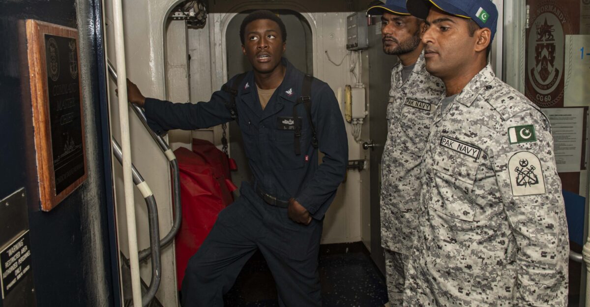 N-PC620-0077 GULF OF OMAN Nov 7 2019 Boatswain s Mate 3rd Class Alton Mccall gives Pakistan navy sailors a tour of the guided-missile cruiser USS Normandy CG 60 during International Maritime Exercise 2019 IMX 19 The exercise is a multinational engagement involving partners and allies from around the world designed to facilitate the sharing of knowledge and experiences across the full spectrum of defensive maritime operations IMX 19 serves to demonstrate the global resolve in maintaining regional security and stability freedom of navigation and the free flow of commerce from the Suez Canal south to the Bab el-Mandeb Strait through the Strait of Hormuz to the Northern Arabian Gulf U S Navy photo by Mass Communication Specialist 2nd Class Michael H Lehman Released