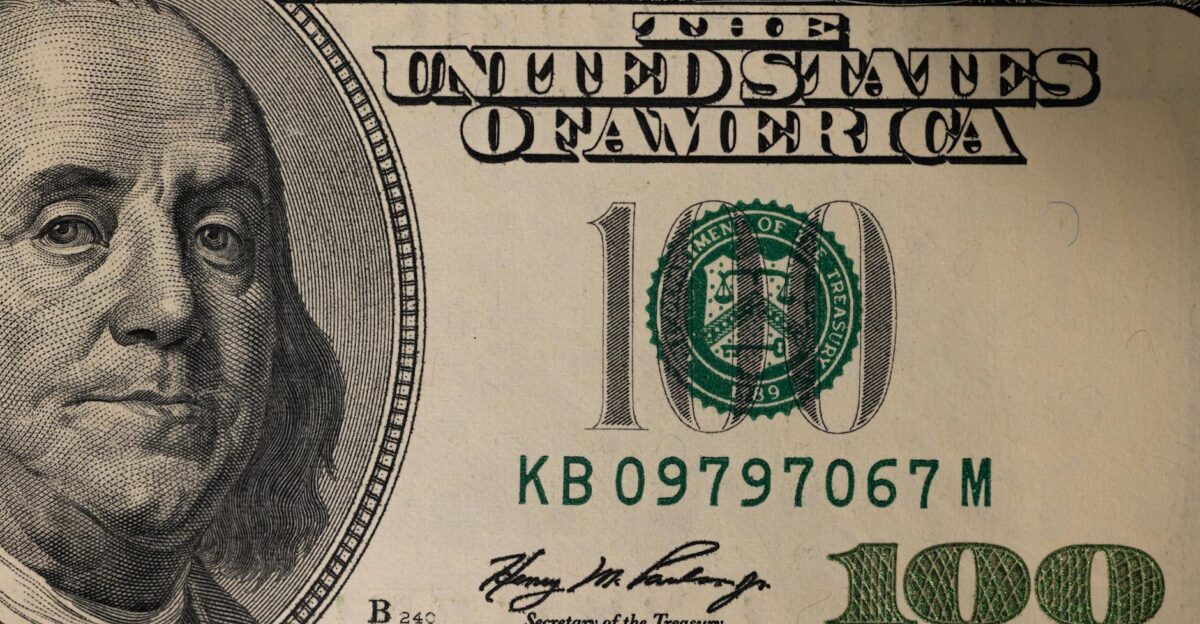 Detailed close-up image of a US one hundred dollar bill showing Benjamin Franklin