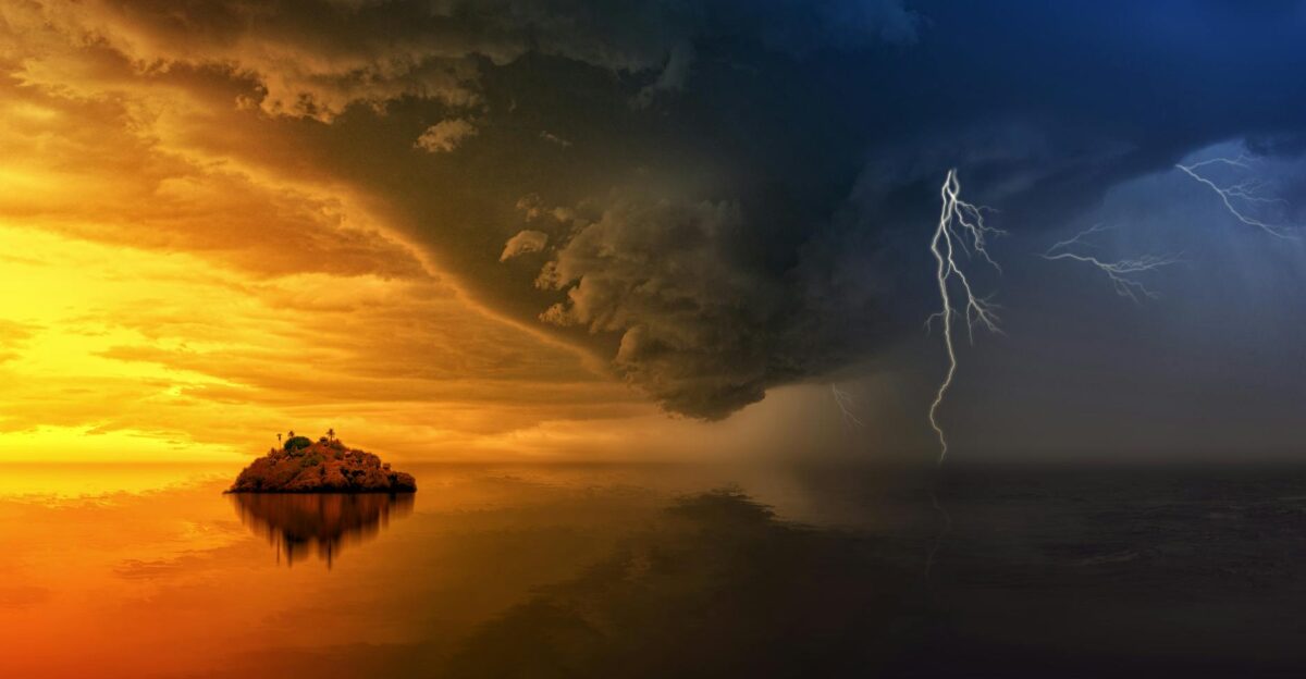 A stunning display of a stormy sunset with lightning striking over a solitary island