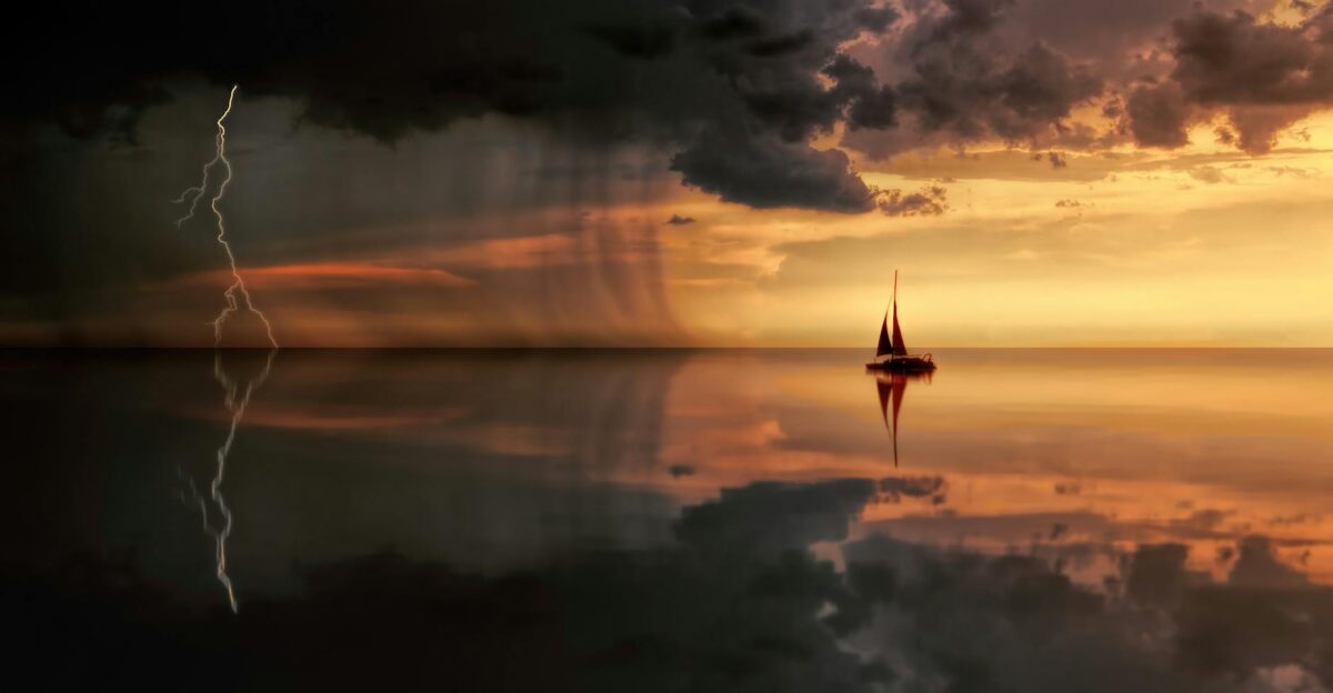 A striking seascape featuring a sailboat lightning and storm clouds at sunset