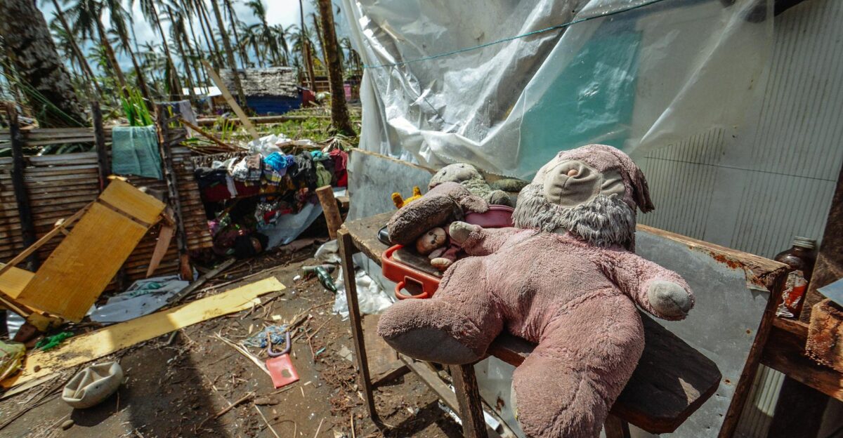 Teddy bears and toys scattered among storm debris highlighting the impact of natural disasters