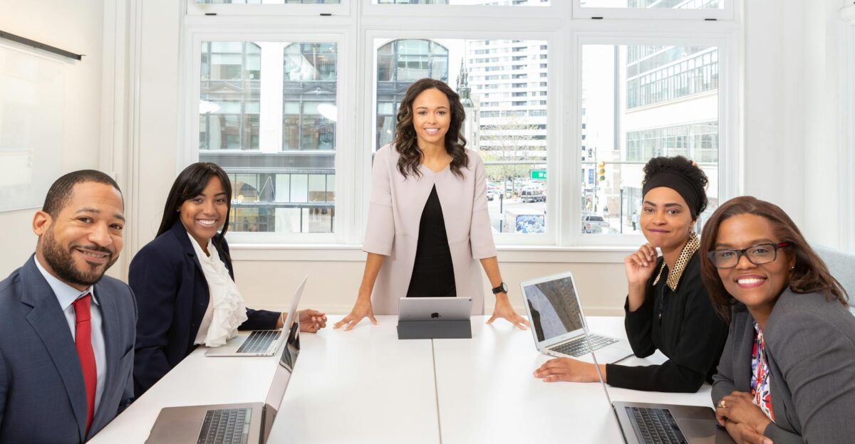 Multicultural team collaborating in boardroom with laptops showcasing teamwork and diversity